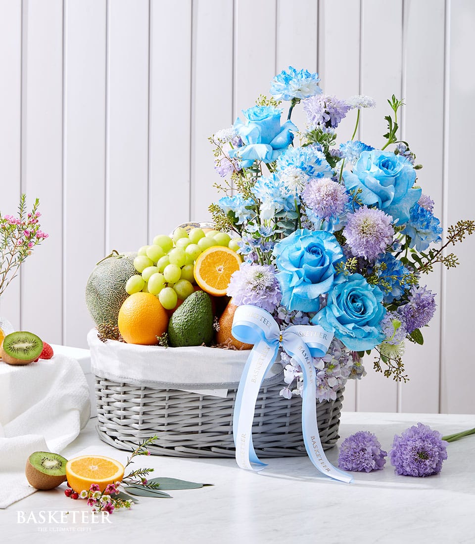 Luxury gift basket with fresh fruit and blue roses, Ecuador sourced florals with carnations and greenery