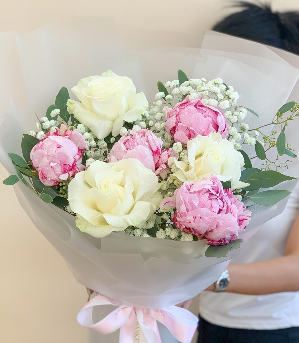 Fresh white rose and pink peony bouquet with eucalyptus, perfect for graduation or celebrating her