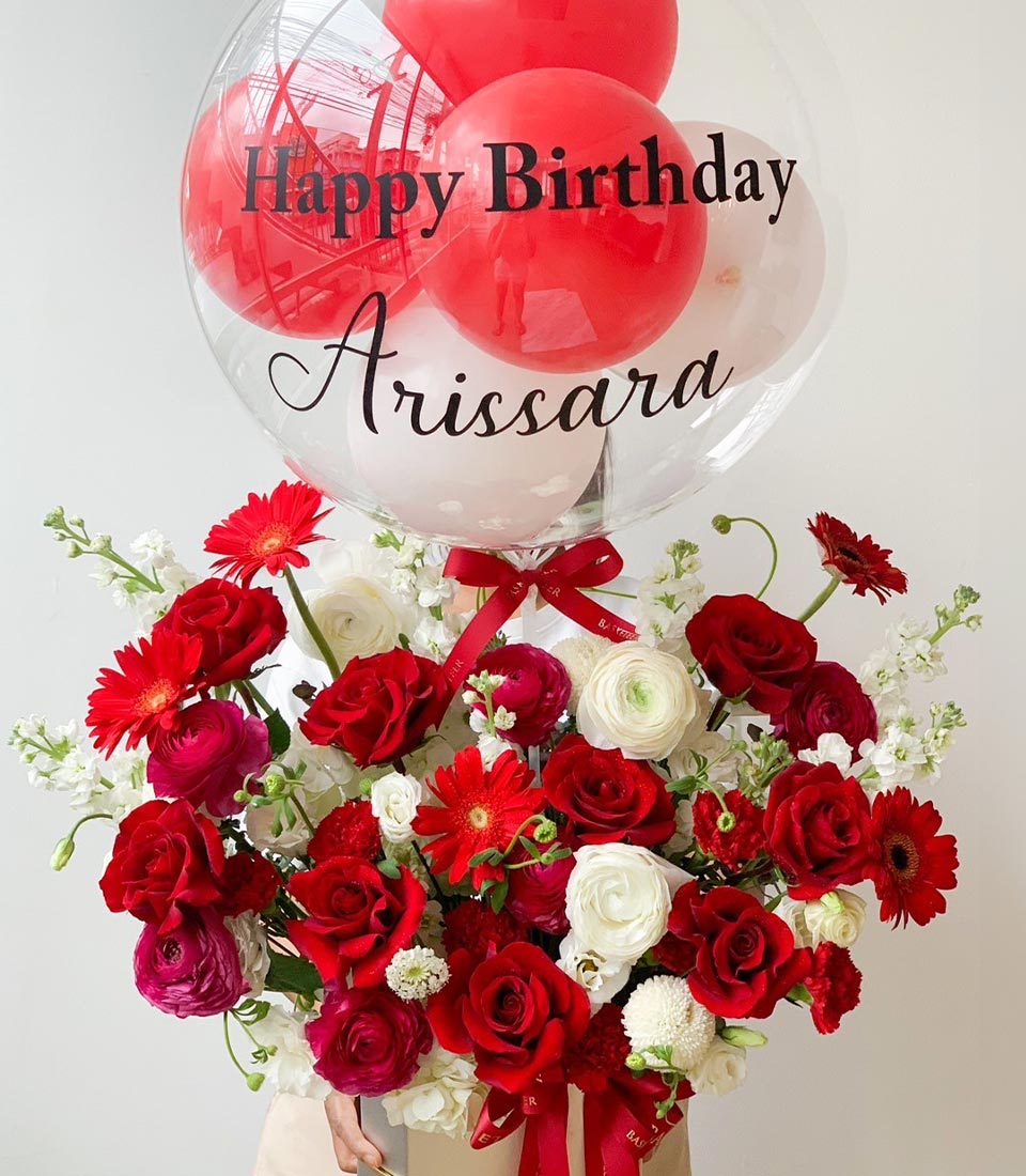Red and white roses with gerbera daisies and personalized birthday balloon gift arrangement