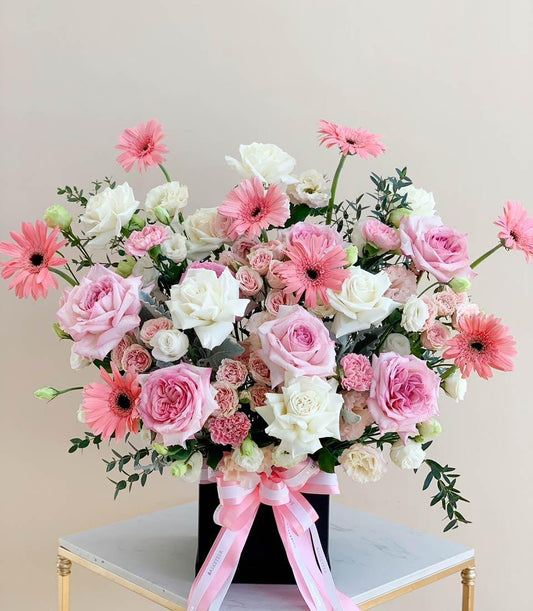 Pink and white roses with gerbera daisies in luxury black box, graduation congratulations flowers