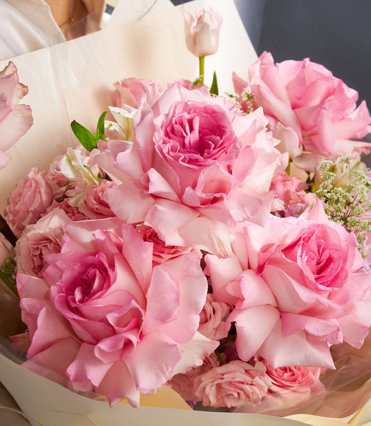 Elegant pink rose bouquet with white alstroemeria and tulip, premium Ecuador blooms wrapped in beige paper