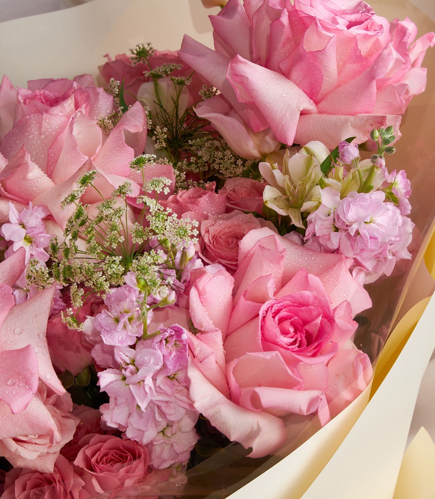Elegant pink rose bouquet with white filler flowers and fresh greenery, artisan arrangement for gifting