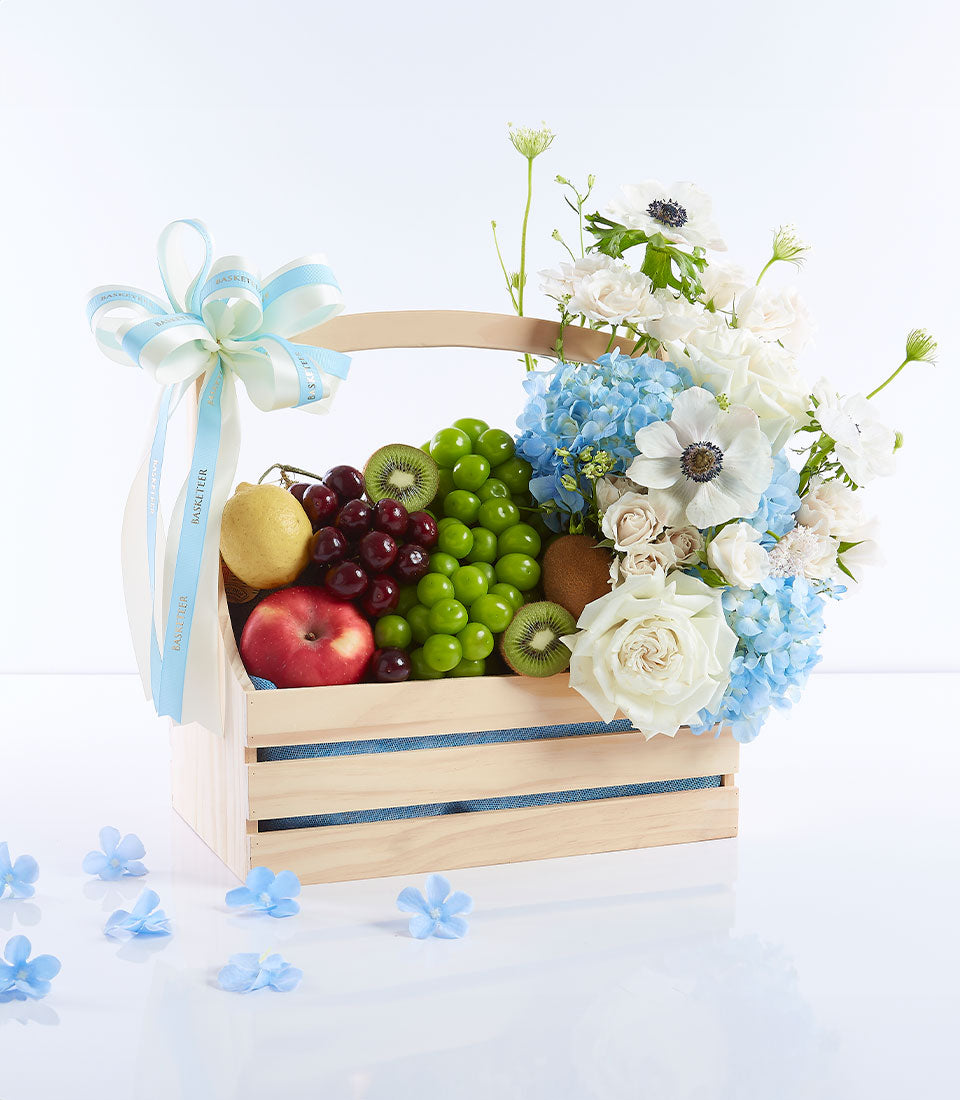 Blue Serenity wooden crate with fresh fruit, hydrangeas, and roses for Mother's Day