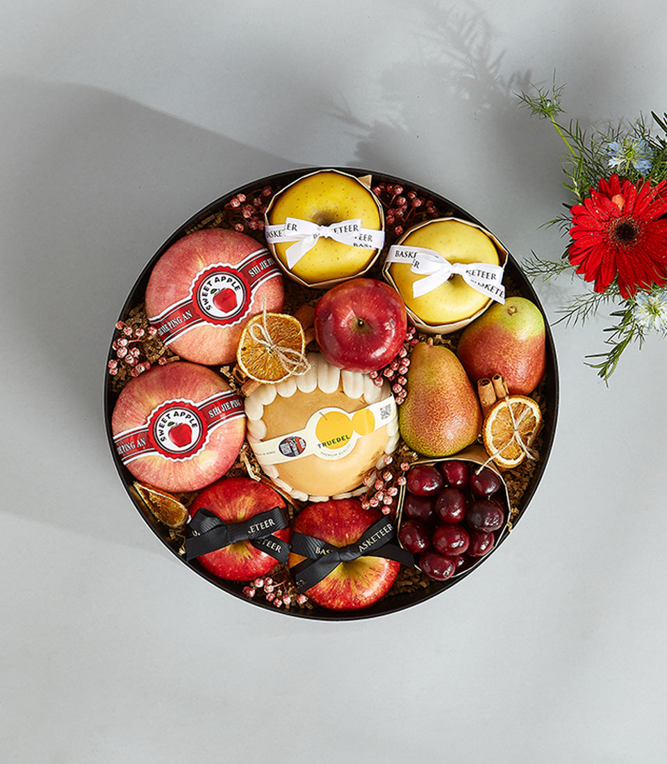 Premium fresh fruit gift basket with Korean pears, apples, cheese, and seasonal produce in black round box