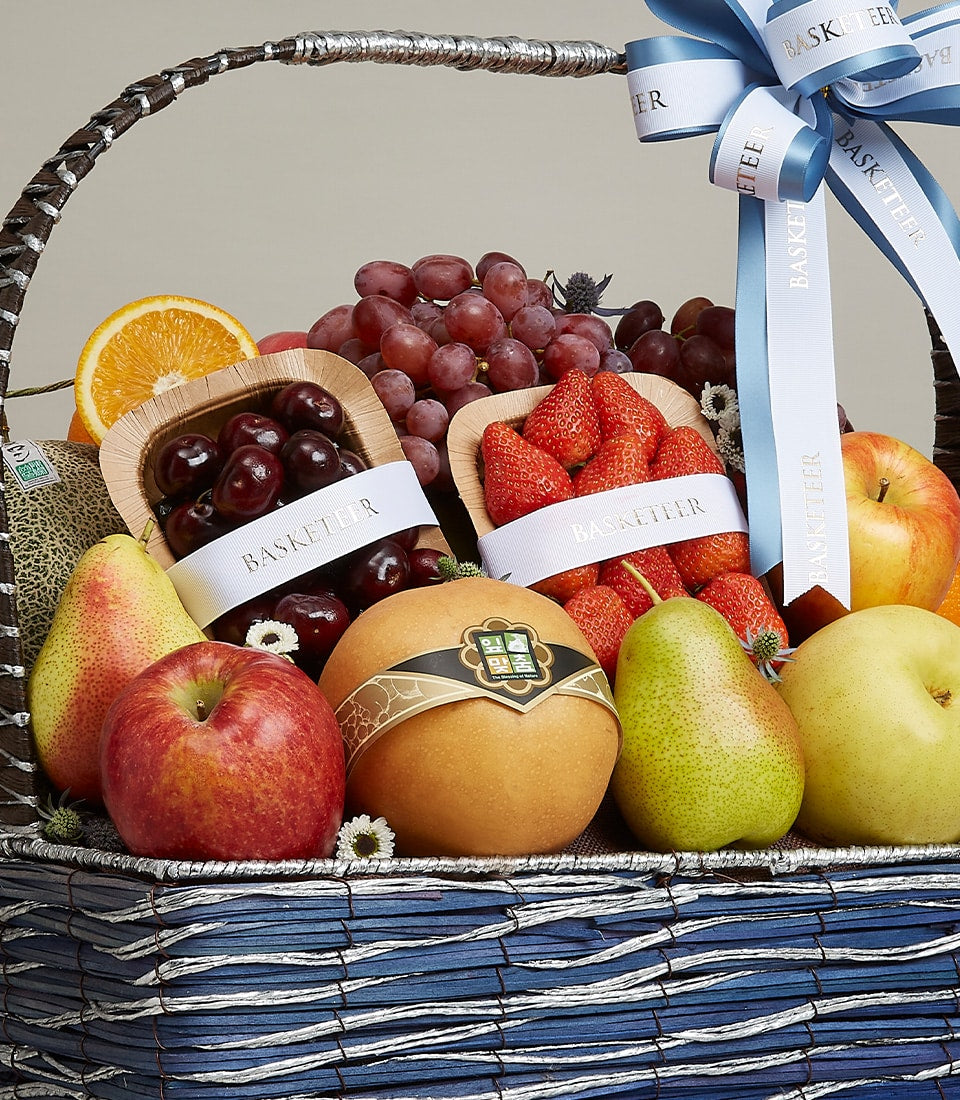 Premium fruit gift basket with fresh cherries, strawberries, grapes, apples, pears and Asian pear in woven brown basket with