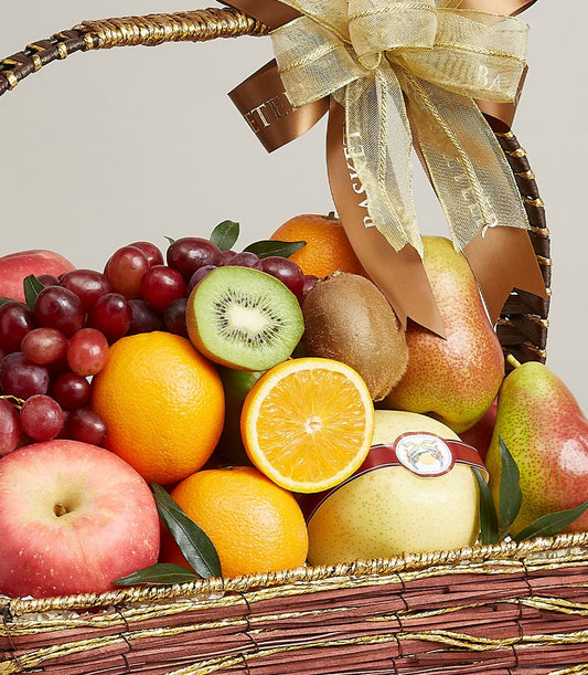 Dark woven fruit gift basket with red grapes, oranges, kiwis, apples, pears and gold ribbon bow