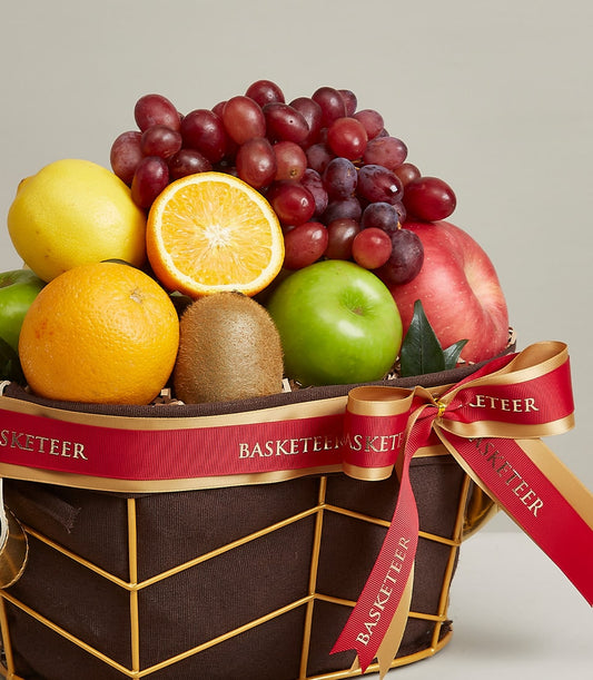 Premium mixed fruit basket with grapes, apples, citrus in gold wire frame and burgundy ribbon