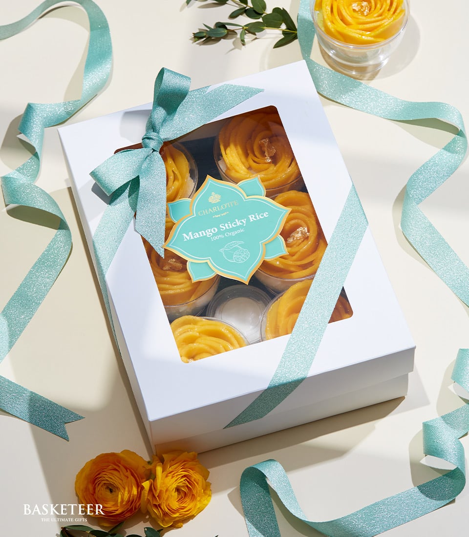 Mango sticky rice gift set with six artisan servings in flower-shaped presentation, light blue ribbon bow