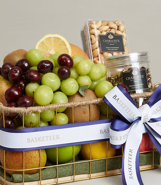 Luxe gold wire fruit basket with fresh grapes, kiwis, pears, apples, cashews and seed mix, white ribbon bow