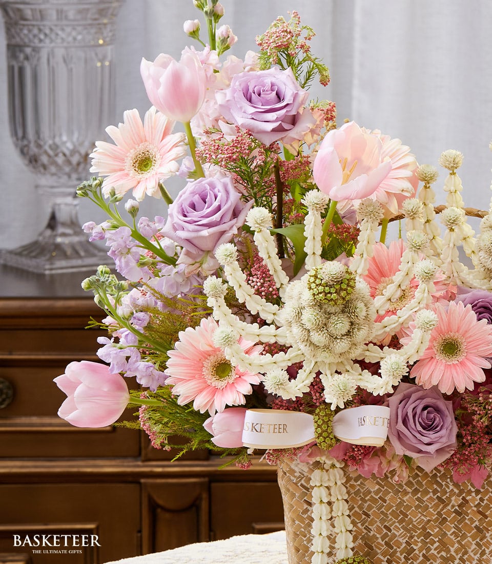 Soft pastel pink and lavender roses with tulips and gerbera daisies in woven basket, Thai New Year Songkran gift