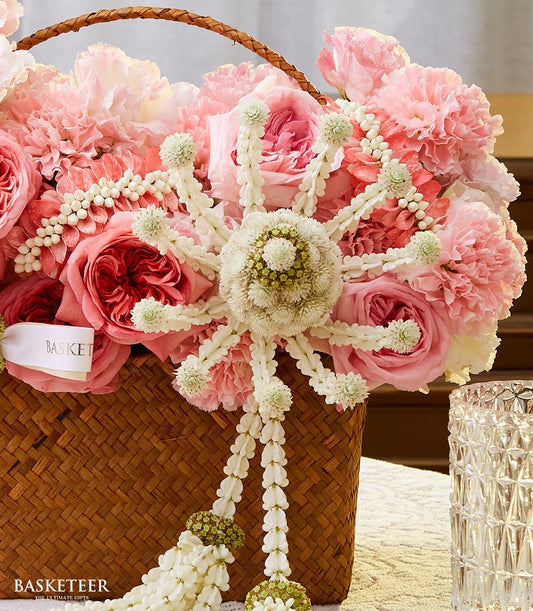 Pink and white roses in woven Thai basket with white floral garland, perfect New Year gift