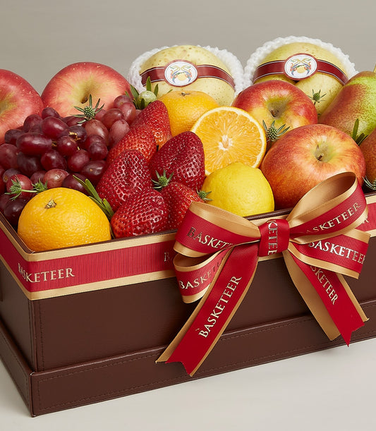 Luxury dark brown leather fruit gift box with red and gold Basketeer ribbon, filled with fresh apples, grapes, strawberries,