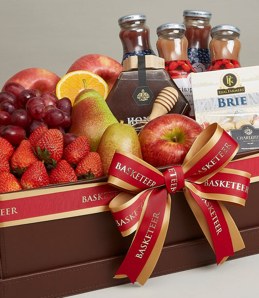 Luxury fruit and gourmet gift basket with fresh apples, pears, strawberries, artisan cheeses, preserves and honey in