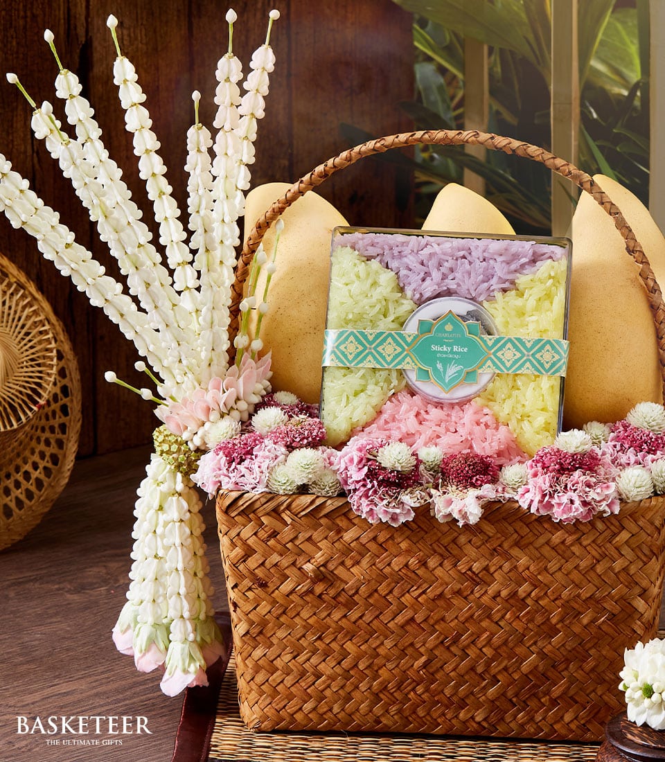 Premium mango and sticky rice gift basket with fresh flowers and woven presentation, curated for Songkran celebrations