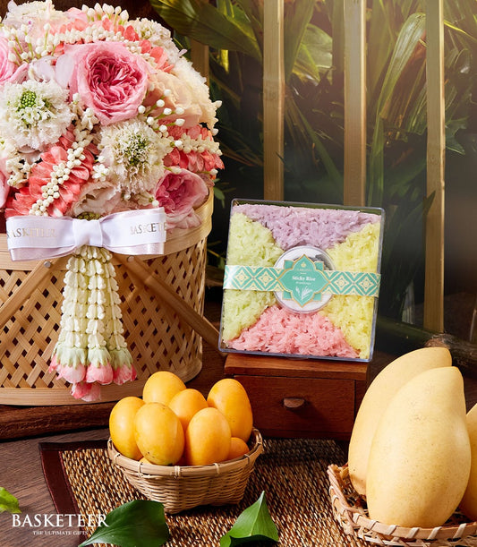 Woven basket with pink and white roses, mango sticky rice set, and fresh Thai mangoes for Songkran New Year