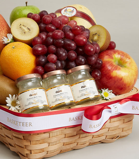 Premium fruit and bird's nest gift basket with fresh grapes, apples, and kiwis in woven wood with gold ribbon