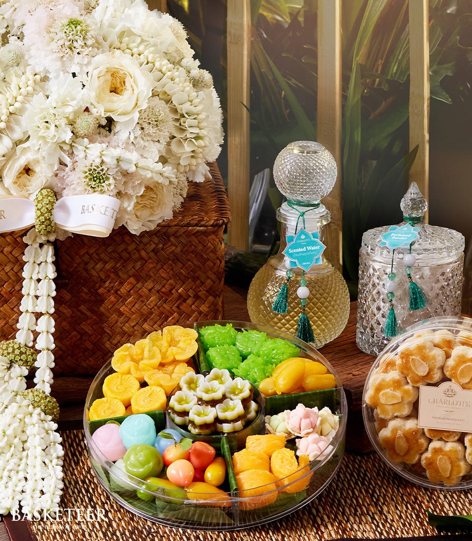 Premium Thai sweets gift set with white roses, scented water, and flower-shaped cookies for Songkran
