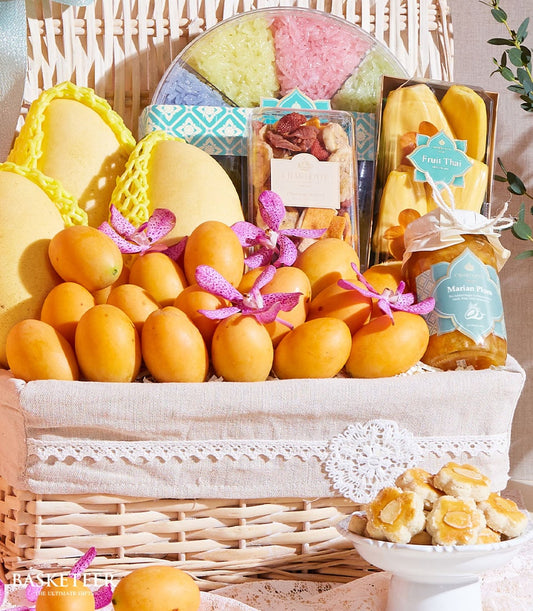 Premium Thai tropical fruit basket with mango, sticky rice, and orchid flowers in woven wicker