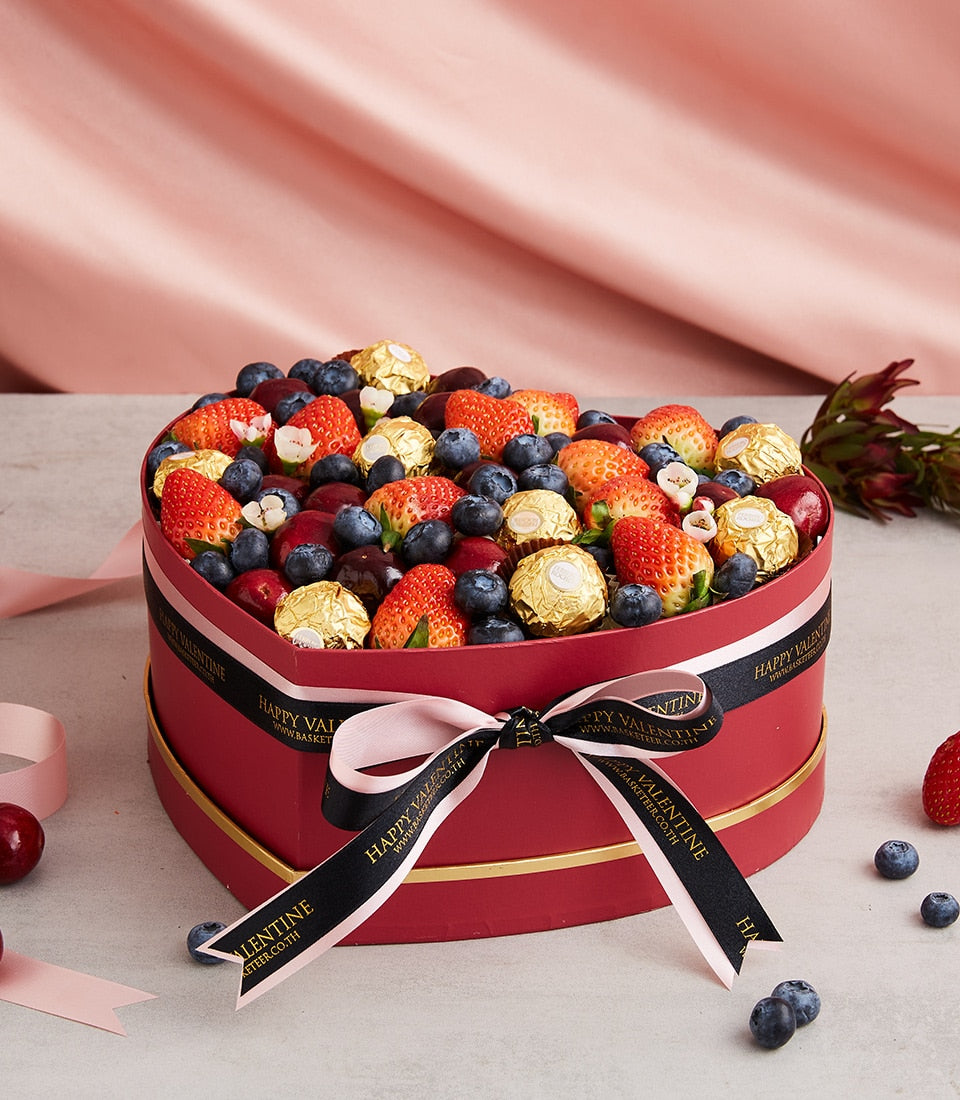 Heart-shaped luxury gift box with fresh strawberries, blueberries, cherries and Ferrero Rocher chocolates, Valentine's Day