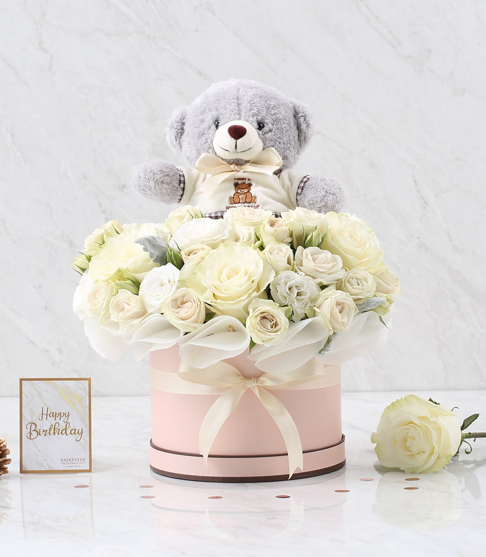 White roses and calla lilies in luxury hat box with teddy bear, birthday gift arrangement