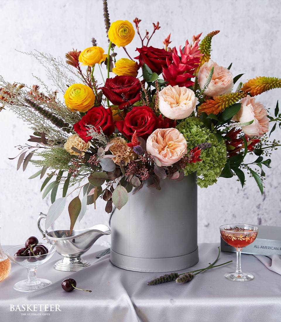 English Juliet David Austin roses with ranunculus and garden roses in light grey luxury hatbox