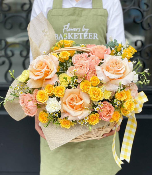 Peach and yellow fresh rose basket with daisy blooms in woven wicker, get well gift arrangement