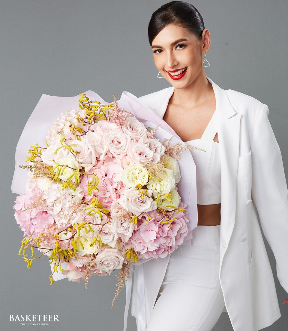 Large luxe Valentine's bouquet of pink roses, yellow roses, and hydrangeas with white wrap and ribbon