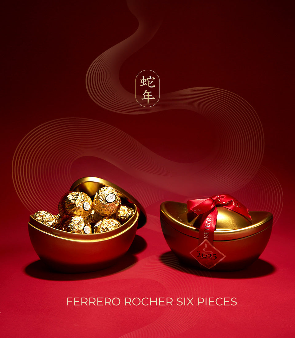 Golden boat-shaped Ferrero Rocher gift set with red ribbon and lucky tag, perfect for Chinese New Year celebrations