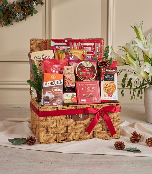 Premium red wicker gift basket filled with gourmet snacks, cocoa, chocolates and biscuits for New Year gifting
