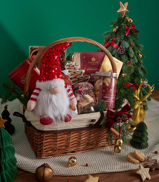 Festive Christmas gift basket with cookies, cocoa, and gnome plush in woven wicker