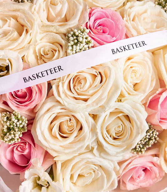 Premium mixed rose bouquet in cream, peach, and pink with white filler flowers, elegant gift arrangement