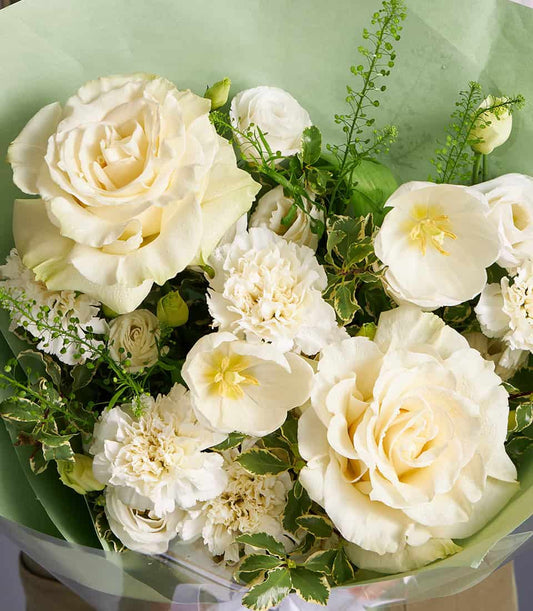 Ivory roses and white chrysanthemums fresh flower bouquet with green foliage