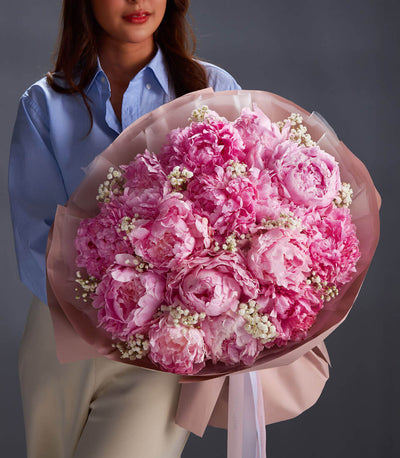 Luxury pink peony bouquet with baby's breath and layered pink wrapping, premium fresh flowers for gifting