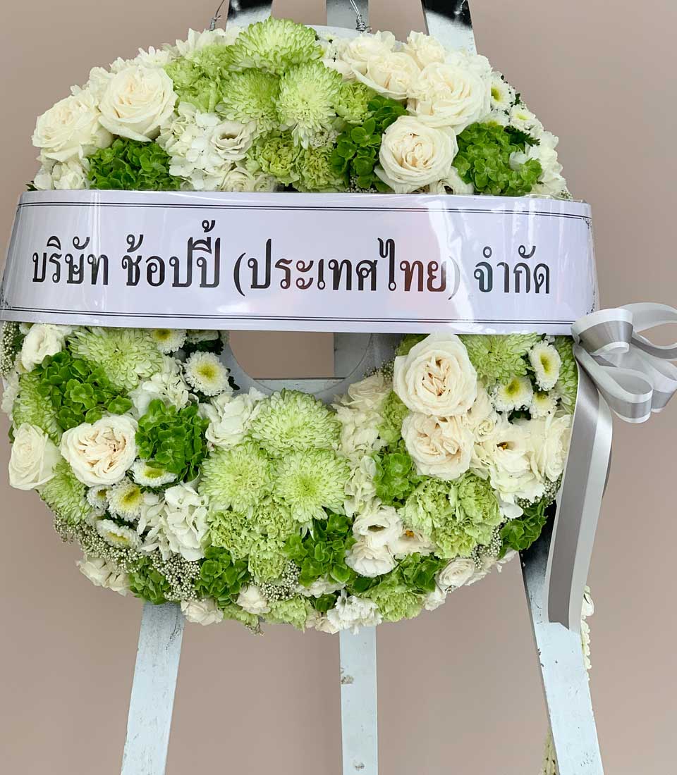 Premium green and white funeral wreath with silk ribbon, elegant floral tribute for farewell blessing