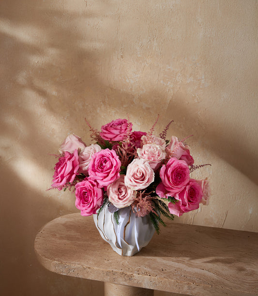 Blush pink roses and astilbe in sculptural grey vase with gold accents, premium fresh flower arrangement for gifting