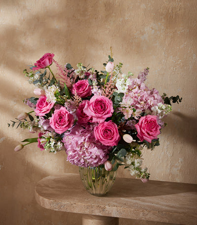 Premium pink and white rose arrangement with hydrangeas and tulips in ribbed glass vase