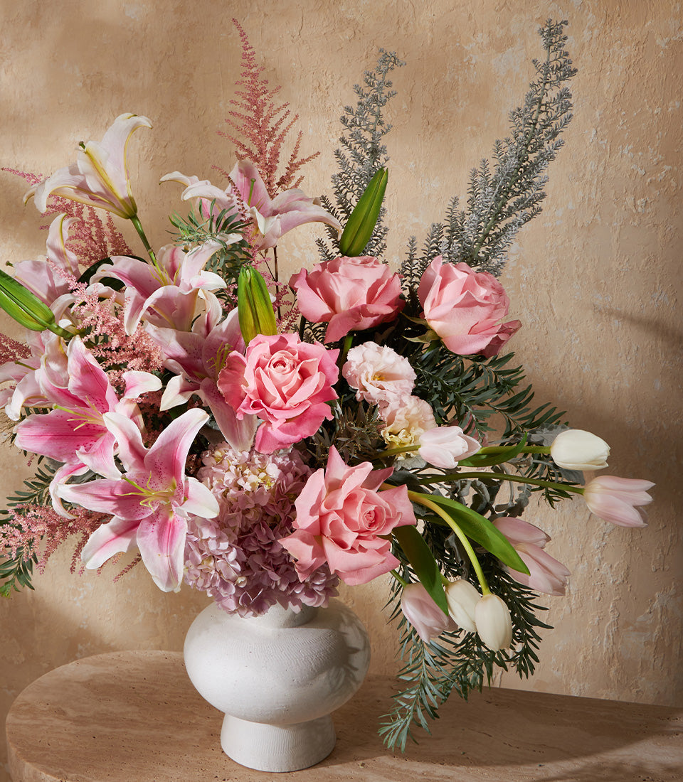 Blush Harmony white ceramic vase with pink roses, lilies, hydrangeas, and astilbe arrangement