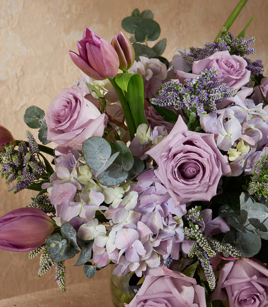 Lavender roses, tulips and hydrangeas in a fresh flower vase arrangement