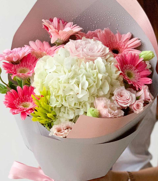Fresh white hydrangea with pink gerberas and roses, graduation congratulations bouquet in textured grey and pink wrap