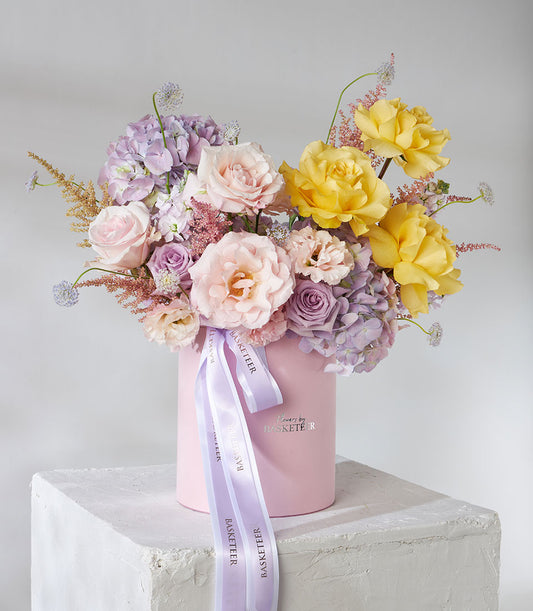 Premium yellow, pink, and purple roses in velvet flower box, luxury birthday gift arrangement