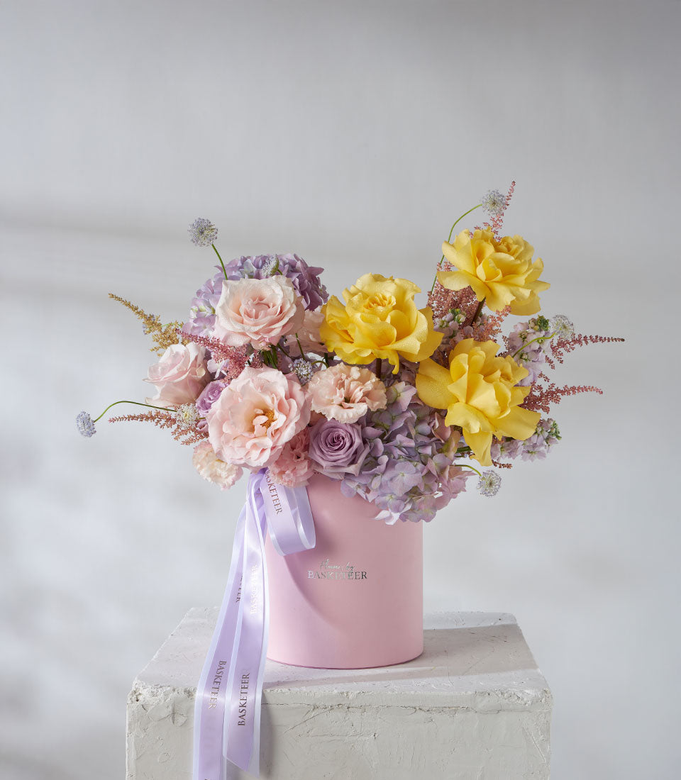 Premium yellow and pink rose arrangement with hydrangeas in velvet hatbox, luxury birthday flowers