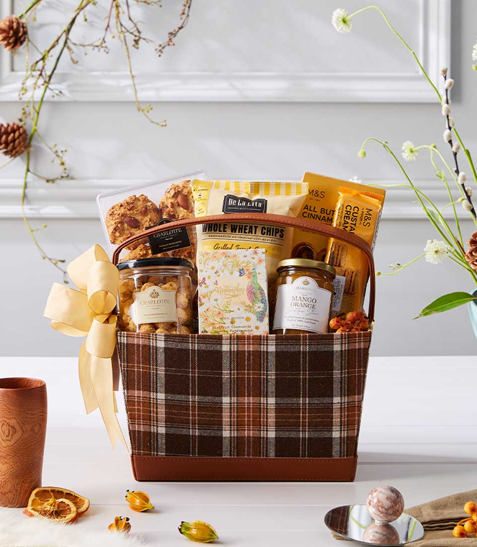 Luxury gift basket with gourmet chocolates, cookies, and preserves in brown plaid, gold ribbon bow—New Year gift hamper