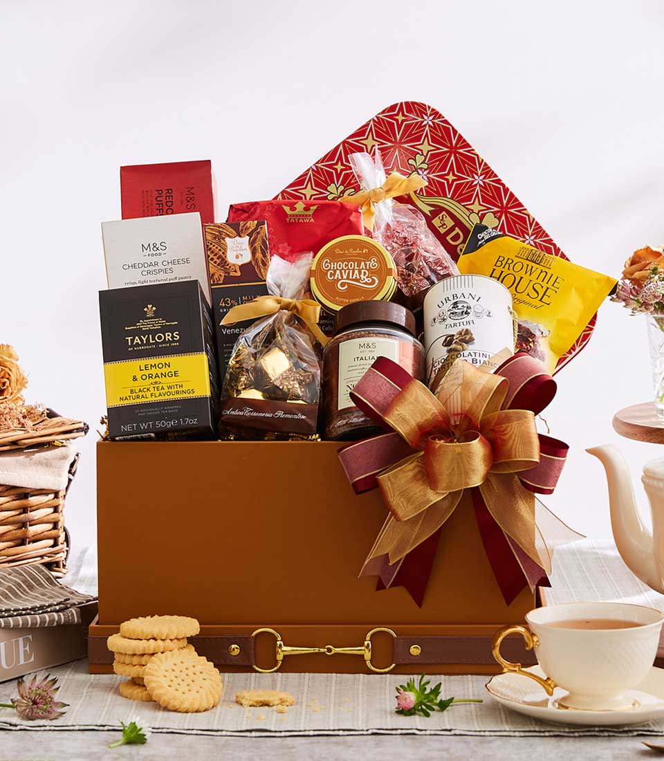 Luxury gourmet gift box with teas, chocolates, and artisan treats, gold accents, New Year gift hamper