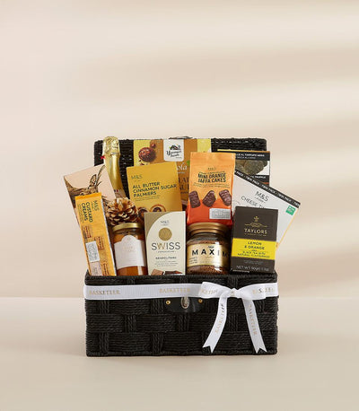 Deluxe black woven gift basket with sparkling wine, gourmet chocolates, and specialty foods for New Year celebrations