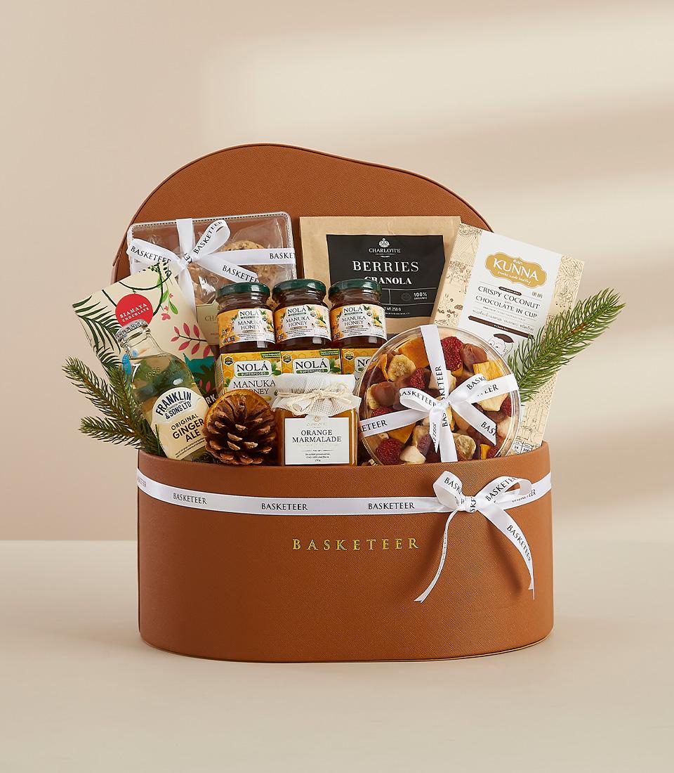 Luxury brown leather round hamper with gourmet honey, marmalade, granola, and dried fruits for New Year gifting