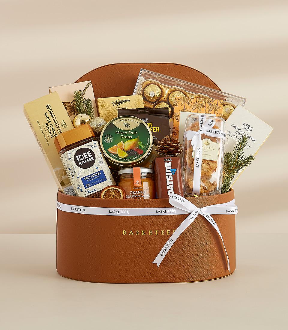 Luxe brown leather round hamper with gourmet chocolates, coffee, marmalade, and festive trimmings for New Year gifting