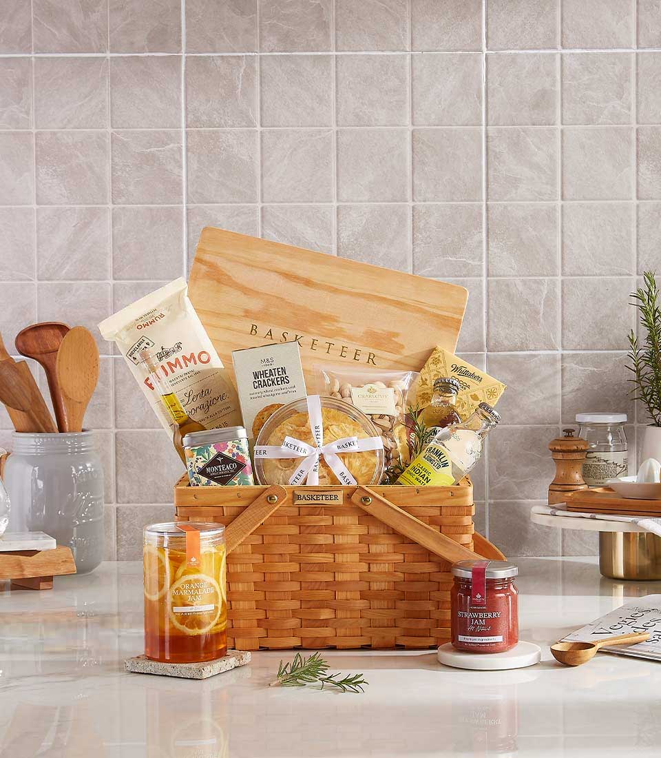 Basketeer premium hamper delivery Thailand. Wicker basket gift with crackers, nuts, jam and wooden cutting board. Perfect corporate gift Bangkok.