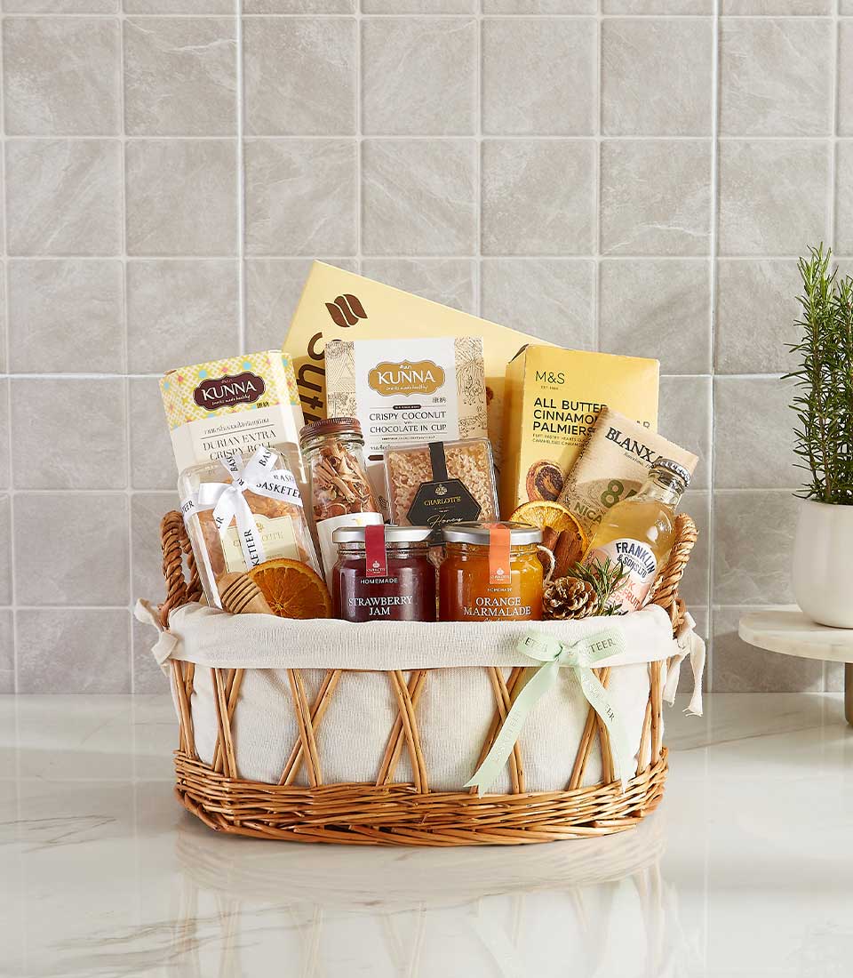 Woven wicker Me Time gift basket with gourmet snacks, jams, sparkling drink, and dried citrus for New Year wellness gifting