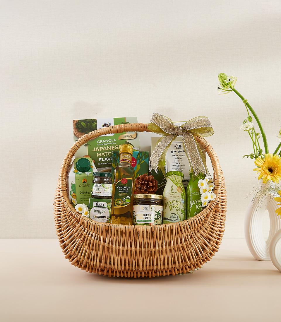 Organic wellness gift basket with matcha granola, coconut nectar, jasmine rice, and fresh gerbera daisies for New Year