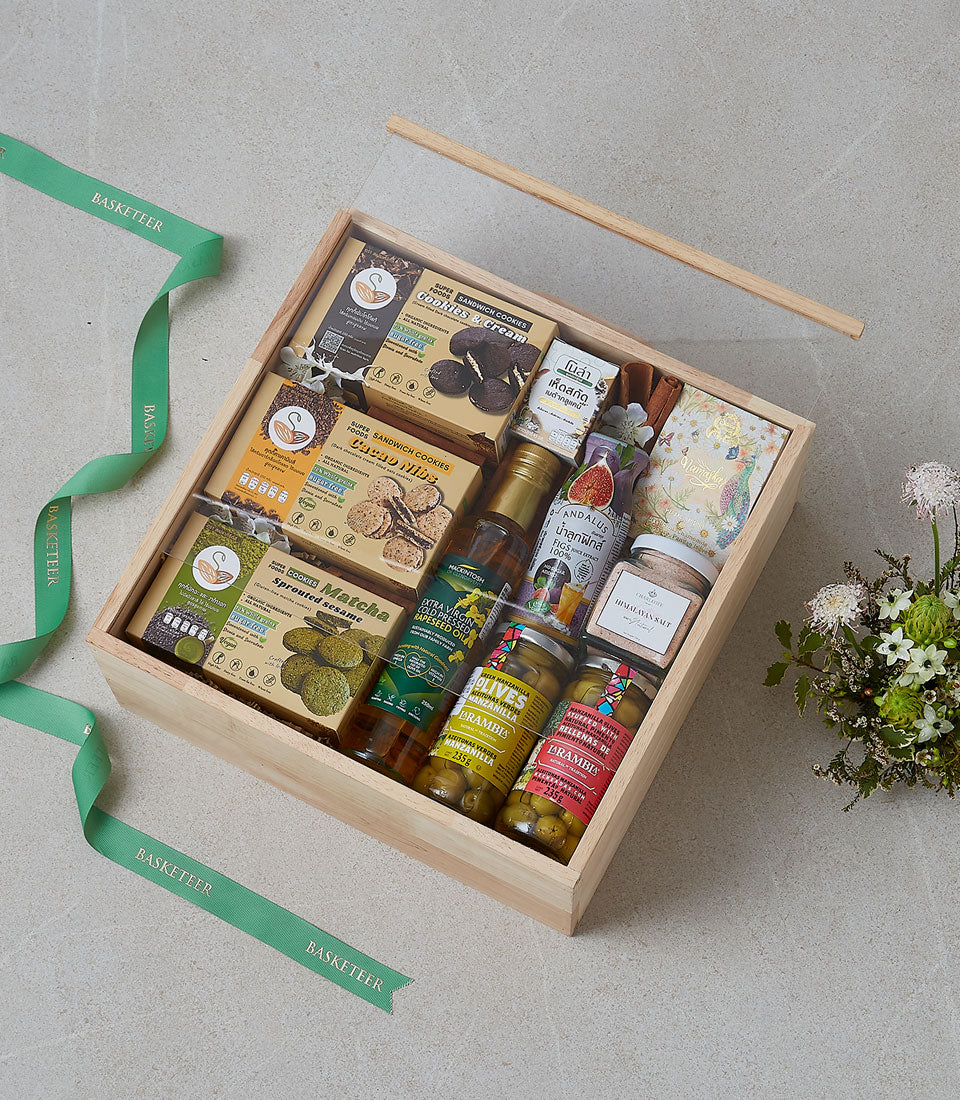 Wooden gift box filled with gourmet cookies, artisan oils, olives, and figs for premium gifting